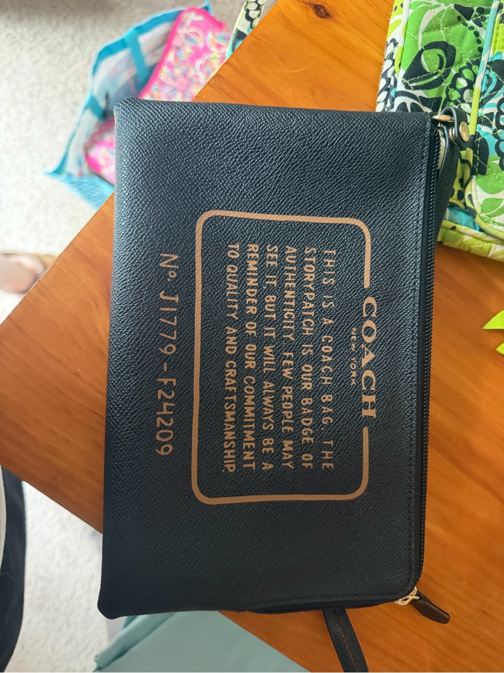 Coach Black Wristlet with Gold Logo Print